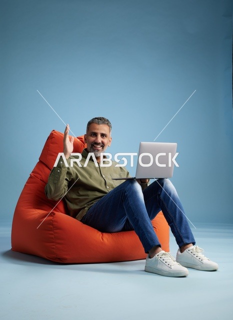 رجل سعودي يعمل على جهاز كمبيوتر محمول