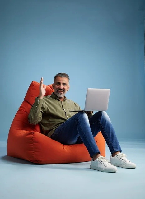 Saudi Man Working on Laptop on Bean Bag