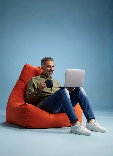 Saudi Man Working on Laptop on Bean Bag