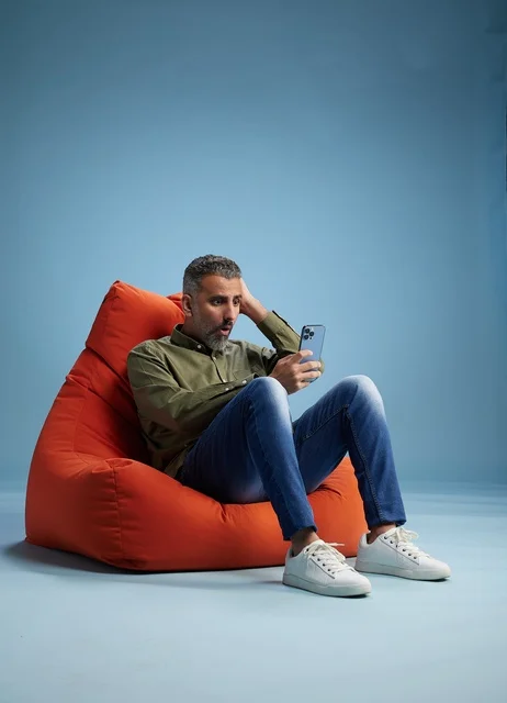 Surprised Saudi Man Using Smartphone in Studio