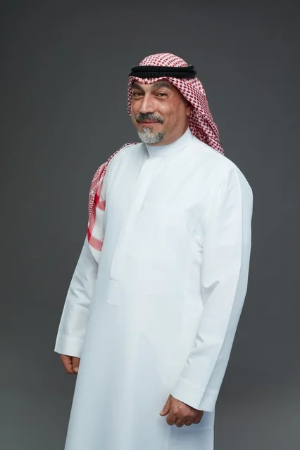Saudi Man in Traditional Dress Portrait on Grey Background