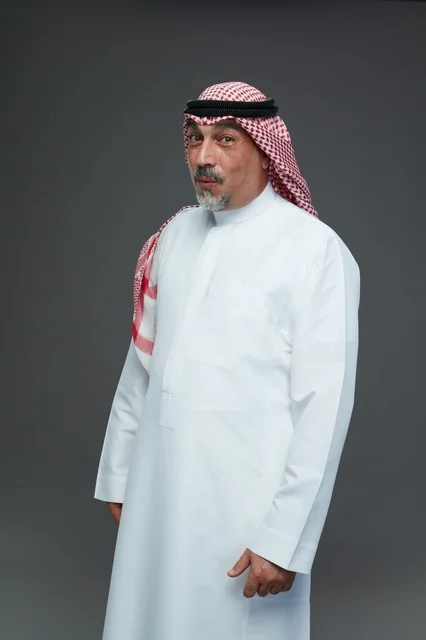 Saudi Man in Traditional White Thobe and Red Shemagh