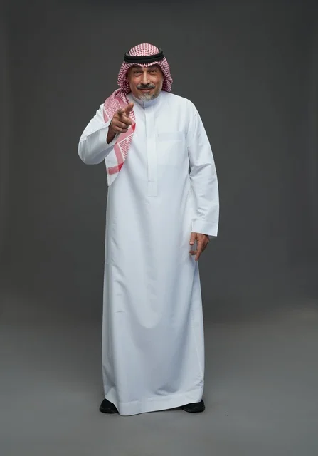 رجل سعودي بالزي التقليدي يشير بإصبعه