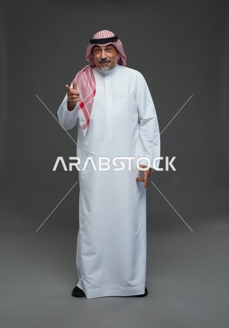 Saudi Man in Traditional Dress Pointing at Camera