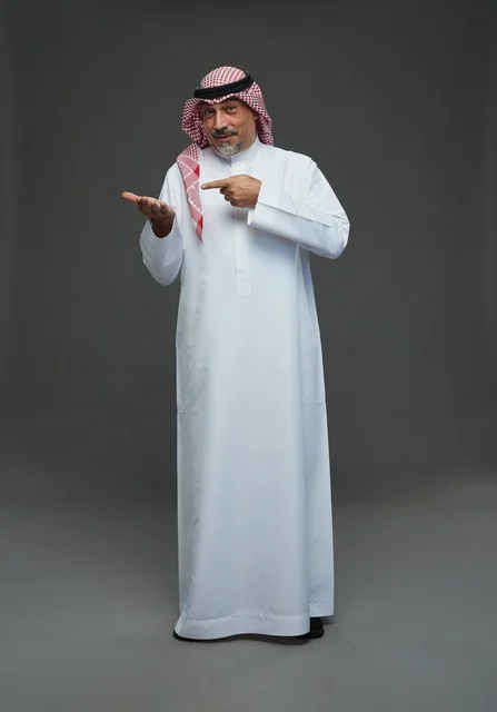 Saudi Man in Traditional Dress Pointing at Hand