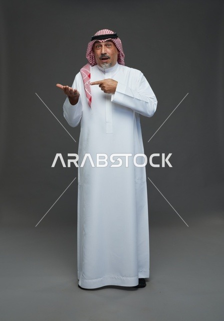 Saudi Man in Traditional Dress Pointing to Hand