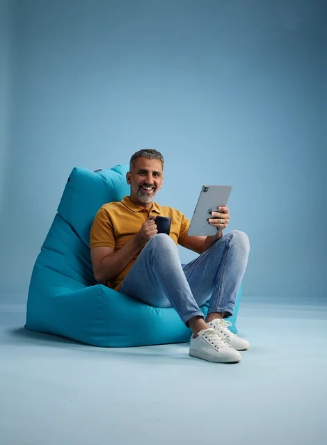 Saudi Man with Tablet and Coffee on Bean Bag