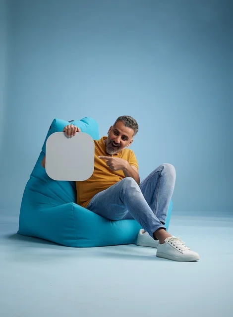 Saudi Man with Blank Mockup Board on Blue Beanbag