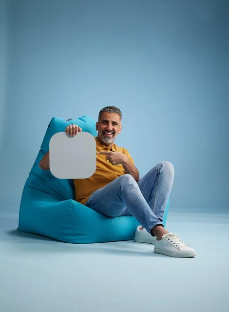 Saudi Man in Studio with Blank Mockup Board on Beanbag