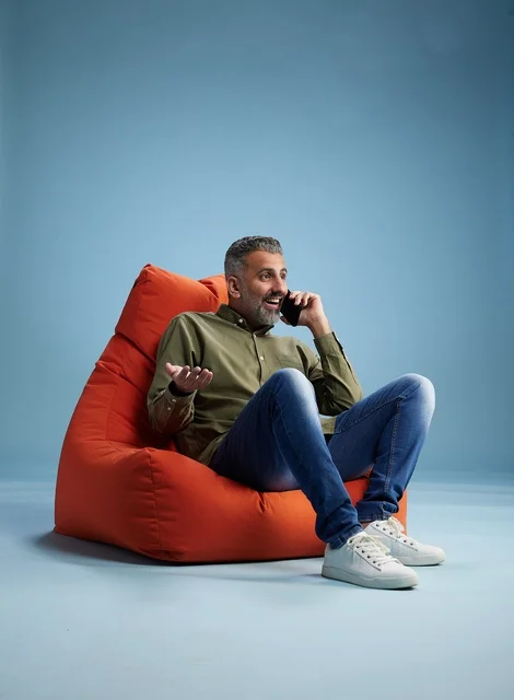 Saudi Man Talking on Smartphone in Orange Beanbag