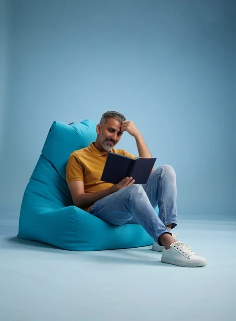 Saudi Man Reading a Book on Beanbag Chair
