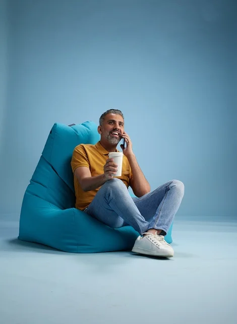 Saudi Man Relaxing on Bean Bag with Coffee