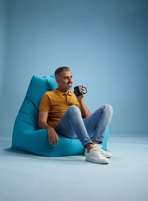 Saudi Man on Blue Bean Bag with Coffee Mug