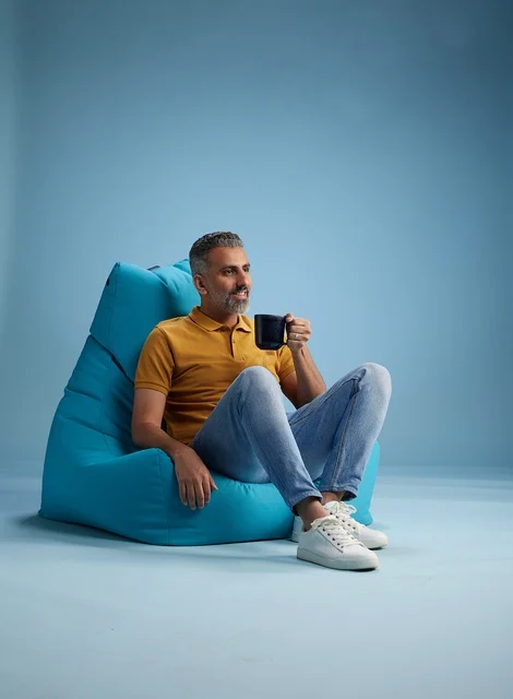 Saudi Man on Bean Bag with Coffee Cup