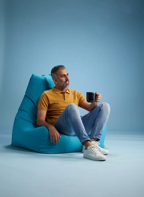 Saudi Man Relaxing on Beanbag with Coffee