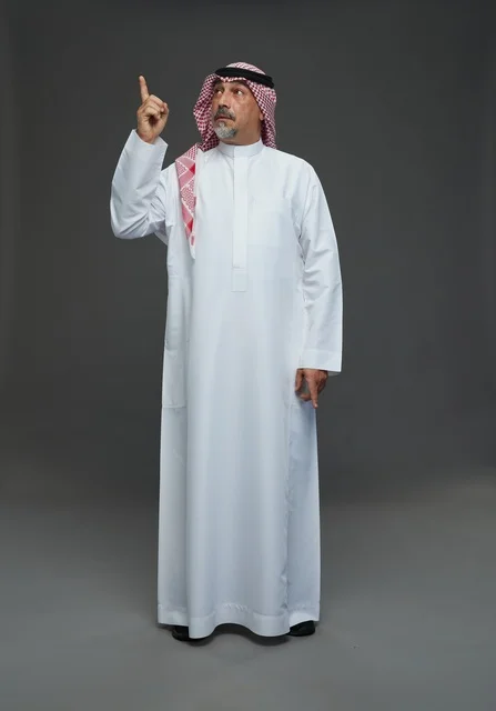 Saudi Man in Traditional Dress Pointing Upwards Studio