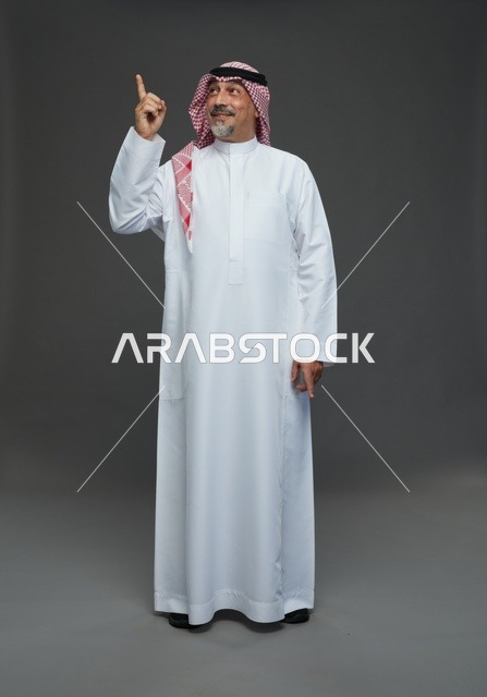 Saudi Man in Traditional Dress Pointing Upward