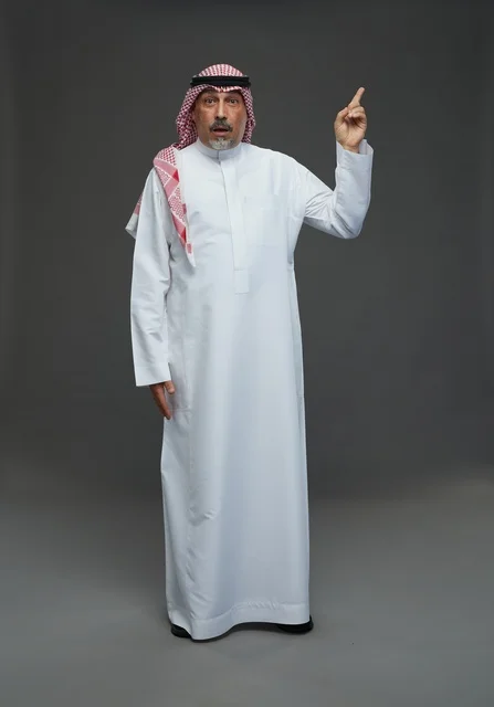 Saudi Man in Traditional Dress Pointing Upwards