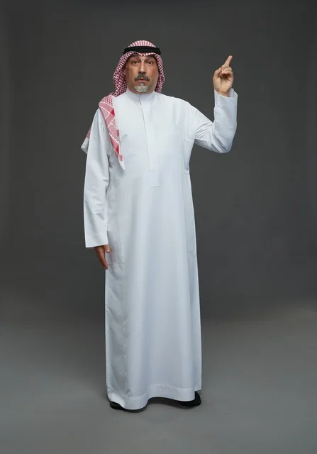 Saudi Man in Traditional White Thobe Pointing Upward
