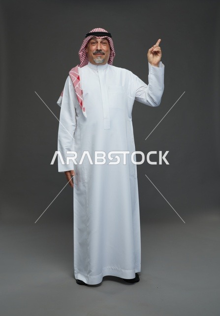 Saudi Man in Traditional Dress Pointing Upwards