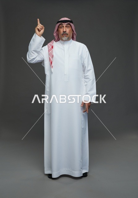 Saudi Man in Traditional Dress Pointing Upward