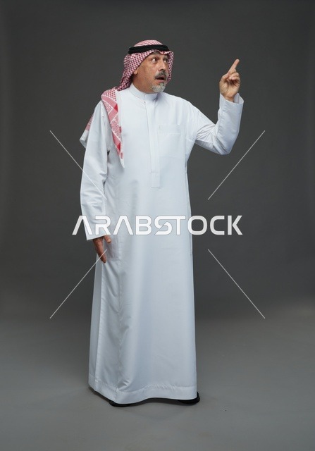 Saudi Man in Traditional Dress Pointing Upwards