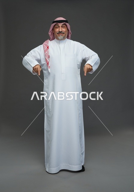 Saudi Man in Traditional Dress Pointing Down