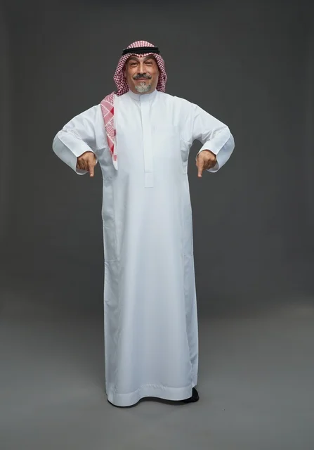 Saudi Man in Traditional Dress Pointing Down