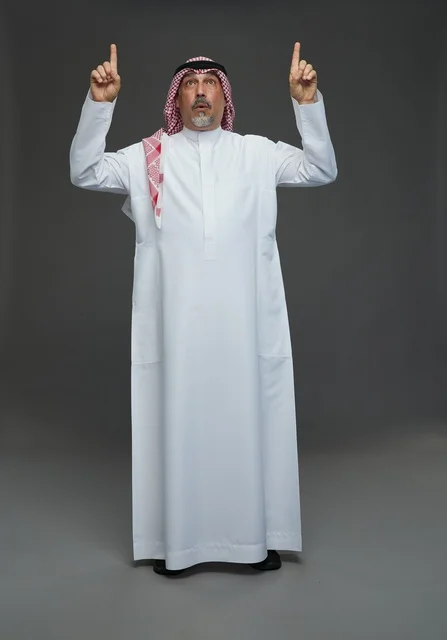 Saudi Man in Traditional Dress Pointing Upwards