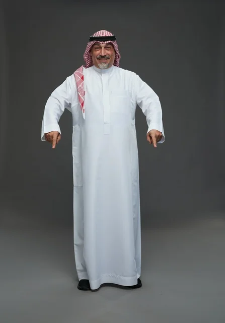 Senior Saudi Man in Traditional Dress Pointing Downward