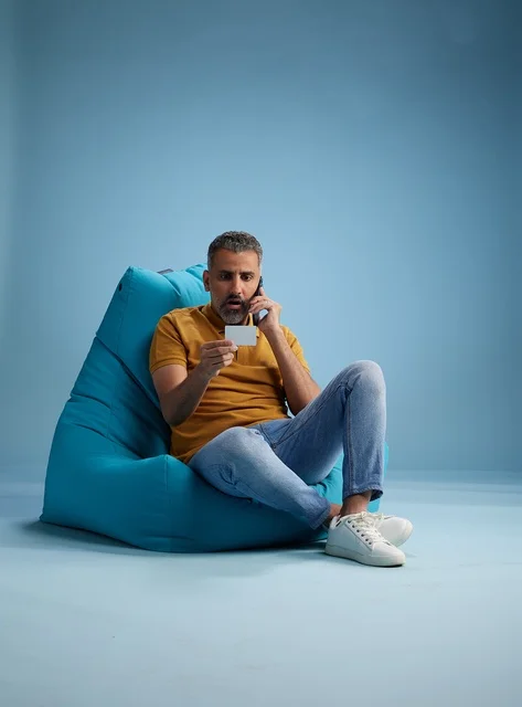 Saudi Man Holding Credit Card on Phone Call