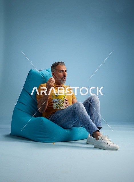 Saudi Man Eating Popcorn on Beanbag Chair