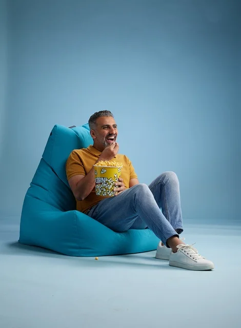 Saudi Man Eating Popcorn in Blue Beanbag Chair