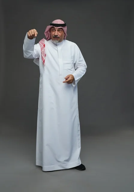 Saudi Man in Traditional Attire Pointing in Studio