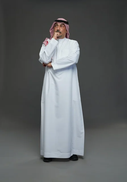Saudi Man in Traditional Thobe and Shemagh Thinking