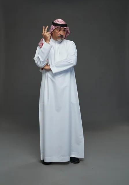 Saudi Man in Traditional Dress on Grey Background