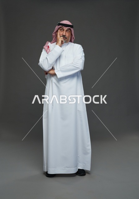 رجل سعودي بالزي التقليدي يفكر في الاستوديو