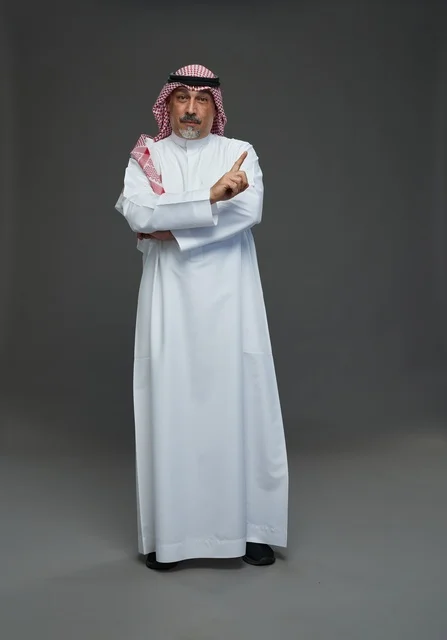 Saudi Man in Traditional Dress Pointing Finger Upward