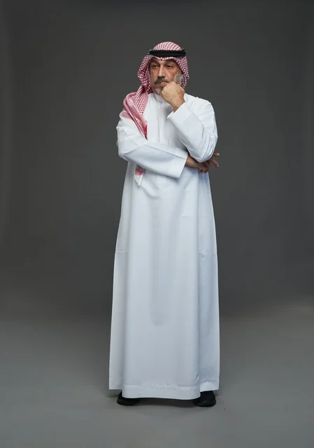 Saudi Man in Traditional Dress on Grey Background
