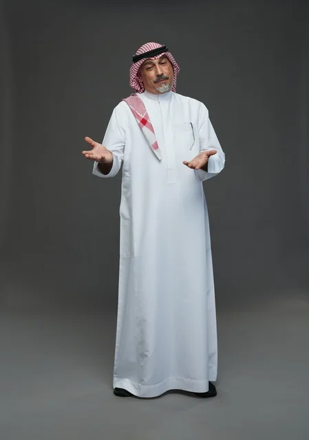 Saudi Man in Traditional Thobe Gesturing on Grey Background