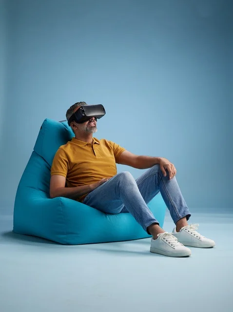 Saudi Man using VR Headset on Blue Bean Bag Chair