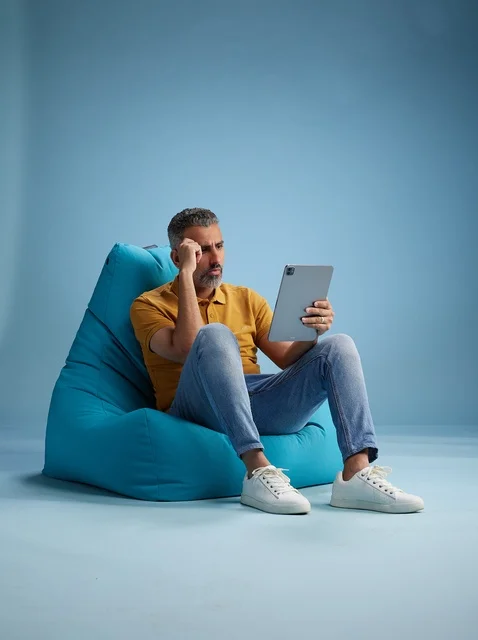 Saudi Man on Bean Bag Using Digital Tablet