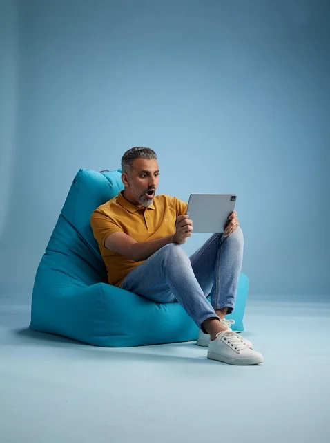 Saudi Man on Bean Bag Using Digital Tablet