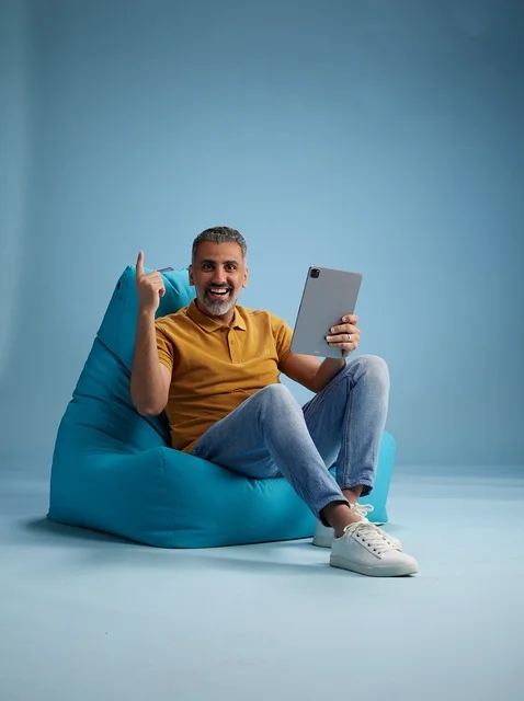 Saudi Man with Tablet on Blue Bean Bag