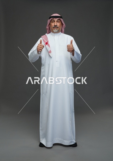 Saudi Man in Traditional Dress Giving Two Thumbs Up