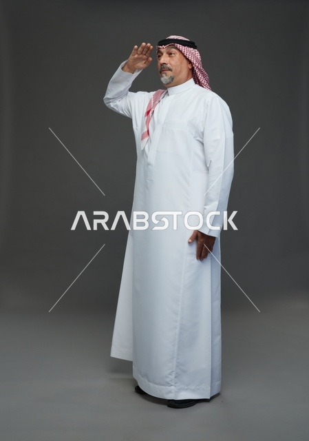 رجل سعودي بالزي التقليدي السعودي يؤدي التحية العسكرية