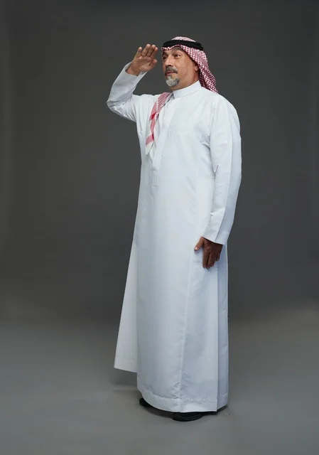 Saudi Man in Traditional Dress Performing Military Salute