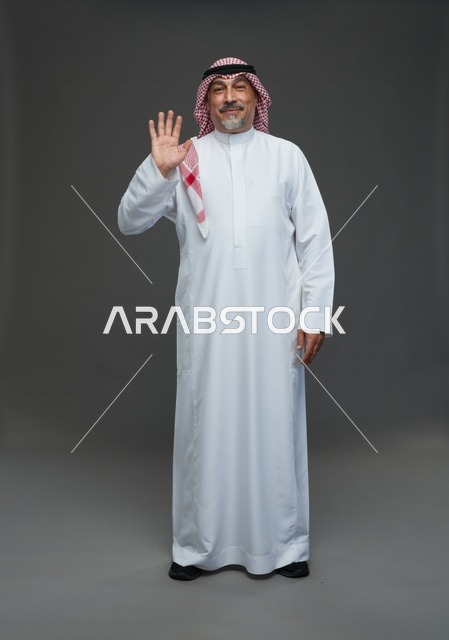 Saudi Man in Traditional Dress Waving on Gray Background