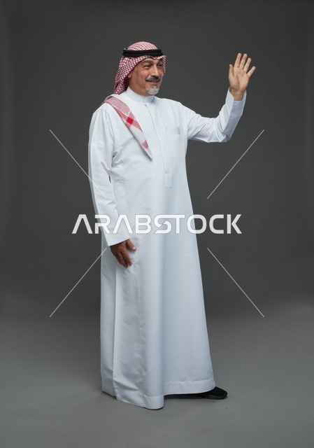 Saudi Man in Traditional Dress Waving in Studio