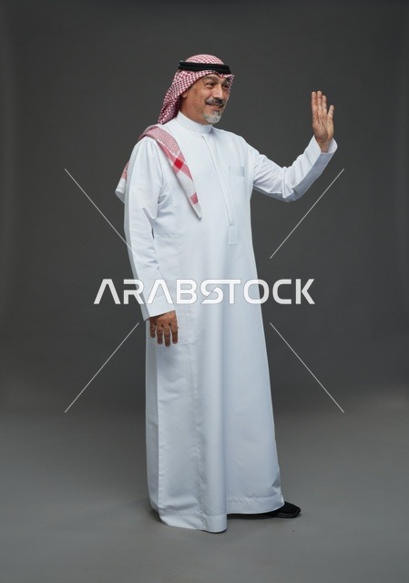 Saudi Man in Traditional Dress Waving Gesture